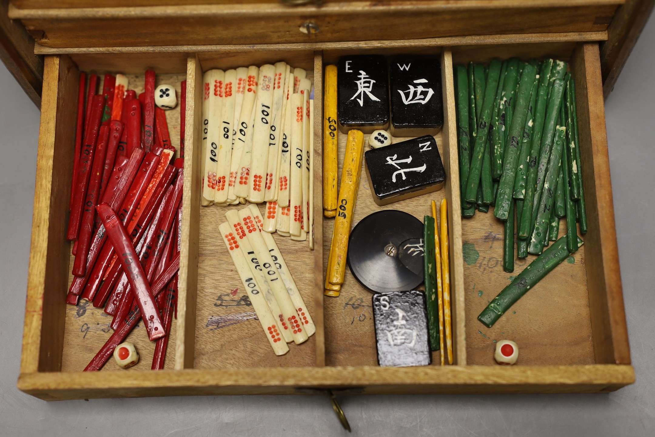 A Chinese bamboo and and bone mahjong set, 18 cms high x 25ms wide.